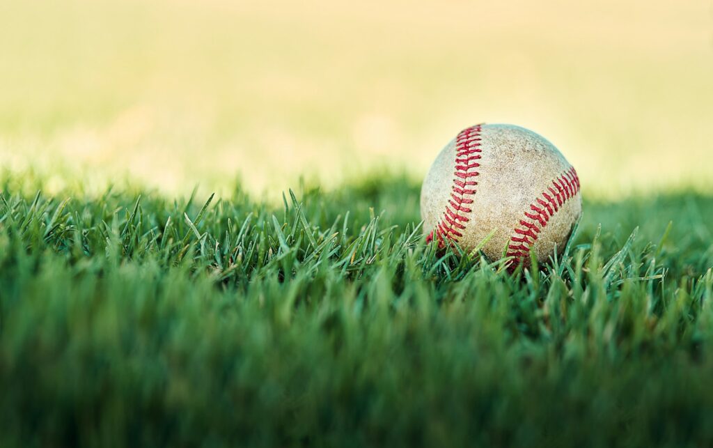 Its baseball time. Shot of a baseball lying on a field.